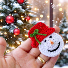 Handmade crochet snowman ornaments with red hats, cute Christmas decor, winter holiday decorations, DIY snowman amigurumi pattern.