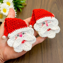 Handmade crochet Santa Claus applique with a red hat and white beard, featuring googly eyes. Perfect for Christmas decorations or as a festive ornament.