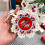 Handmade crochet Christmas wreath ornament with googly eyes and red beads, featuring a playful and festive design, perfect for holiday decor.