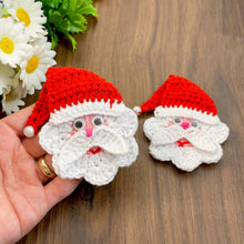 Handmade crochet Santa Claus applique with a red hat and white beard, featuring googly eyes. Perfect for Christmas decorations or as a festive ornament.