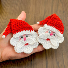 Handmade crochet Santa Claus applique with a red hat and white beard, featuring googly eyes. Perfect for Christmas decorations or as a festive ornament.