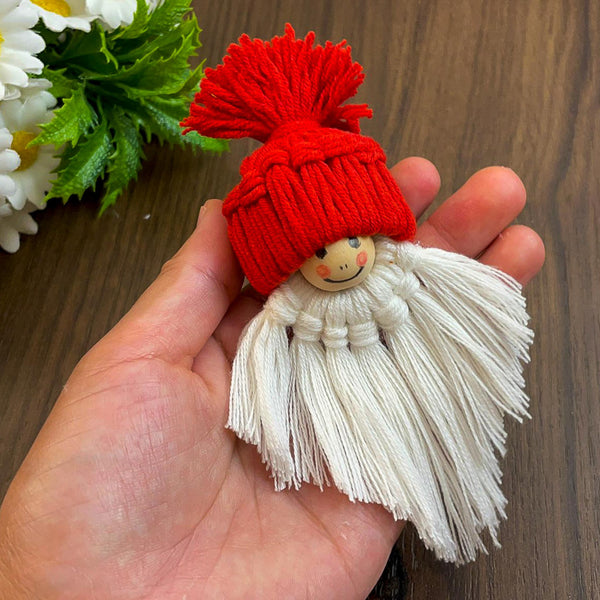 Handmade macrame gnome ornament with a red hat, boho Christmas decor, cute Scandinavian-inspired holiday decoration, DIY gift idea.