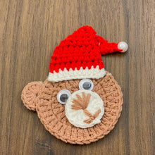 Handmade crochet bear ornament with a Santa hat, cute Christmas decoration, festive amigurumi gift idea, cozy holiday decor for tree or home.