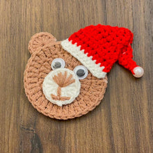 Handmade crochet bear ornament with a Santa hat, cute Christmas decoration, festive amigurumi gift idea, cozy holiday decor for tree or home.