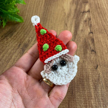 Handmade crochet Christmas elf ornament in red and green with festive hat and detailed face, perfect for holiday decor and DIY Christmas crafts.