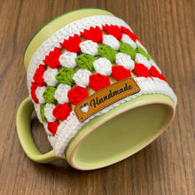 Handmade red, green, and white crochet mug cozy, Christmas-themed decorative cup cover, festive crochet cup sleeve for keeping drinks warm.