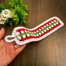 Handmade red, green, and white crochet mug cozy, Christmas-themed decorative cup cover, festive crochet cup sleeve for keeping drinks warm.