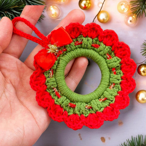 Handmade crochet Christmas wreath ornament with red and green design and decorative bow