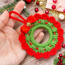 Handmade crochet Christmas wreath ornament with red and green design and decorative bow