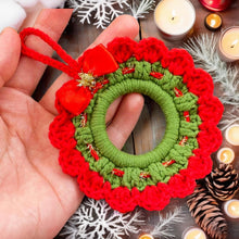 Handmade crochet Christmas wreath ornament with red and green design and decorative bow