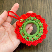 Handmade crochet Christmas wreath ornament with red and green design and decorative bow