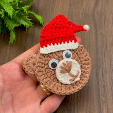 Handmade crochet bear ornament with a Santa hat, cute Christmas decoration, festive amigurumi gift idea, cozy holiday decor for tree or home.