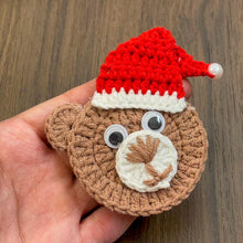 Handmade crochet bear ornament with a Santa hat, cute Christmas decoration, festive amigurumi gift idea, cozy holiday decor for tree or home.