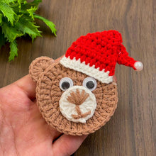 Handmade crochet bear ornament with a Santa hat, cute Christmas decoration, festive amigurumi gift idea, cozy holiday decor for tree or home.
