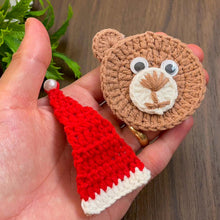 Handmade crochet bear ornament with a Santa hat, cute Christmas decoration, festive amigurumi gift idea, cozy holiday decor for tree or home.