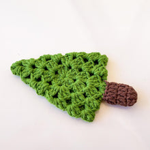 A handmade crochet pine tree keychain with a vibrant green top and a textured brown trunk, designed as a cute and eco-friendly accessory. Perfect for use as a keychain, bag charm, or small Christmas tree ornament.