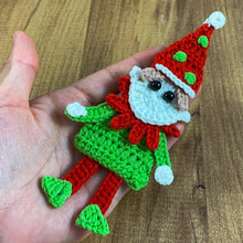 Handmade crochet Christmas elf ornament in red and green with festive hat and detailed face, perfect for holiday decor and DIY Christmas crafts.