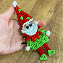Handmade crochet Christmas elf ornament in red and green with festive hat and detailed face, perfect for holiday decor and DIY Christmas crafts.