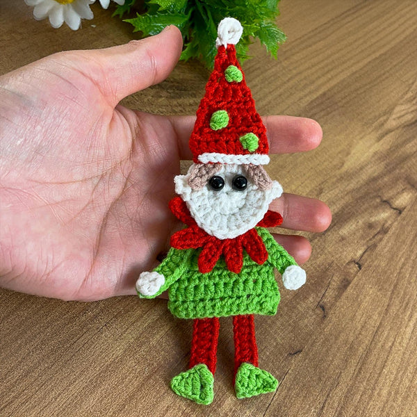 Handmade crochet Christmas elf ornament in red and green with festive hat and detailed face, perfect for holiday decor and DIY Christmas crafts.