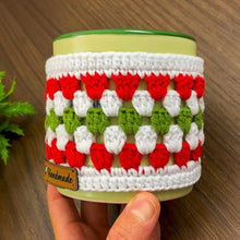 Handmade red, green, and white crochet mug cozy, Christmas-themed decorative cup cover, festive crochet cup sleeve for keeping drinks warm.