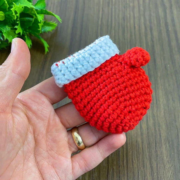 Handmade red crochet mini Christmas mitten, perfect for holiday decoration, Christmas tree ornament, gift tag, and home decor.