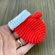 Handmade red crochet mini Christmas mitten, perfect for holiday decoration, Christmas tree ornament, gift tag, and home decor.