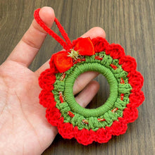 Handmade crochet Christmas wreath ornament with red and green design and decorative bow