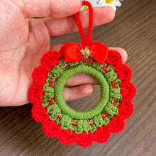 Handmade crochet Christmas wreath ornament with red and green design and decorative bow