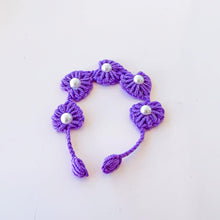 Handmade purple crochet bracelet with pearl accents, delicate floral design for a unique boho-style accessory