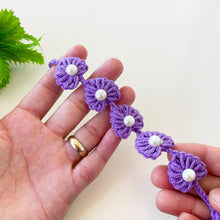 Handmade purple crochet bracelet with pearl accents, delicate floral design for a unique boho-style accessory